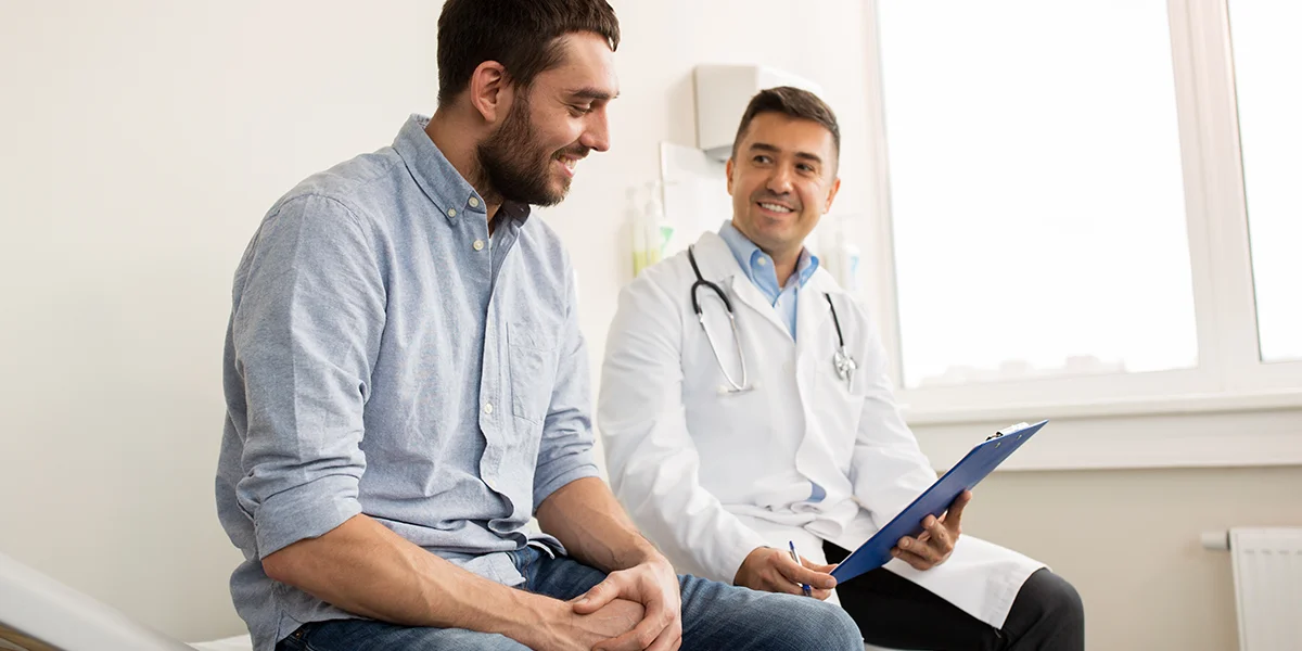 Caucasian man talking to his doctor