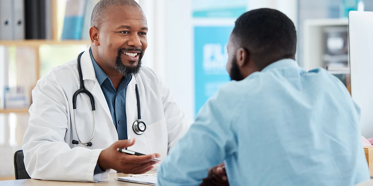 Young Black man talking to a male infertility specialist