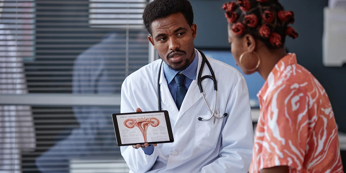 Young Black woman talking to a young Black doctor about egg donation