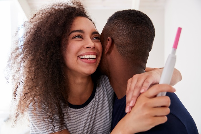 Black couple happy about a positive pregnancy test