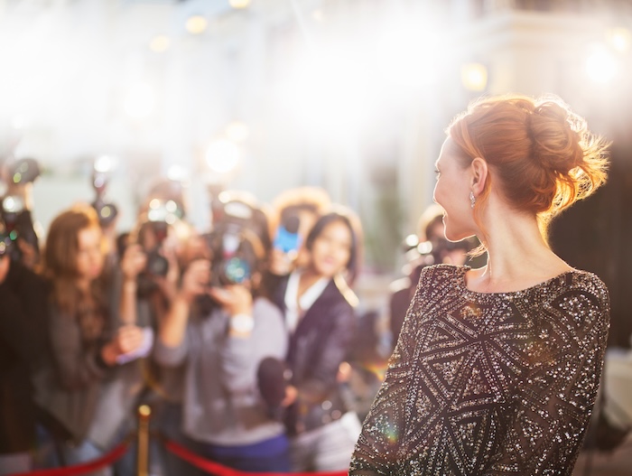Red haired female celebrity posing for photos