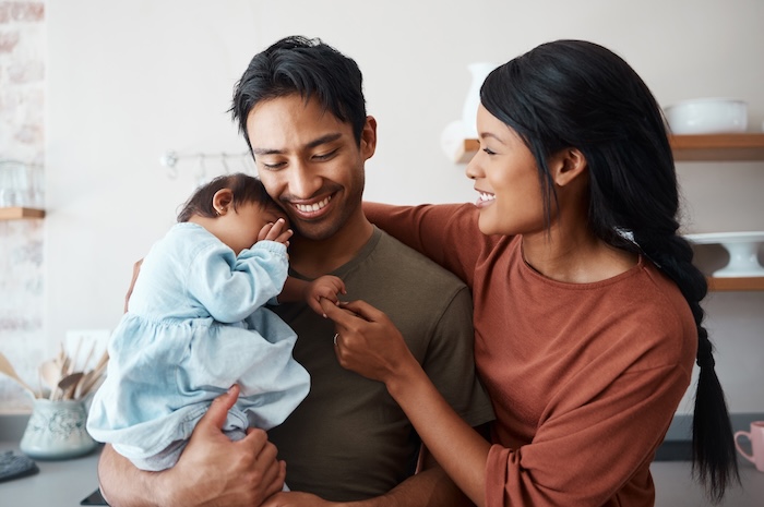 Ethnically ambiguous parents bonding with their baby girl