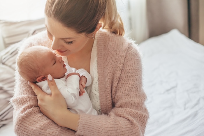 Caucasian mom holding her new baby