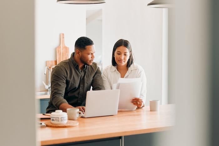 Young couple browsing an egg donor database. 