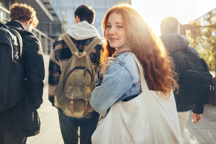 Pretty redheaded teen looking backwards at the camera. 
