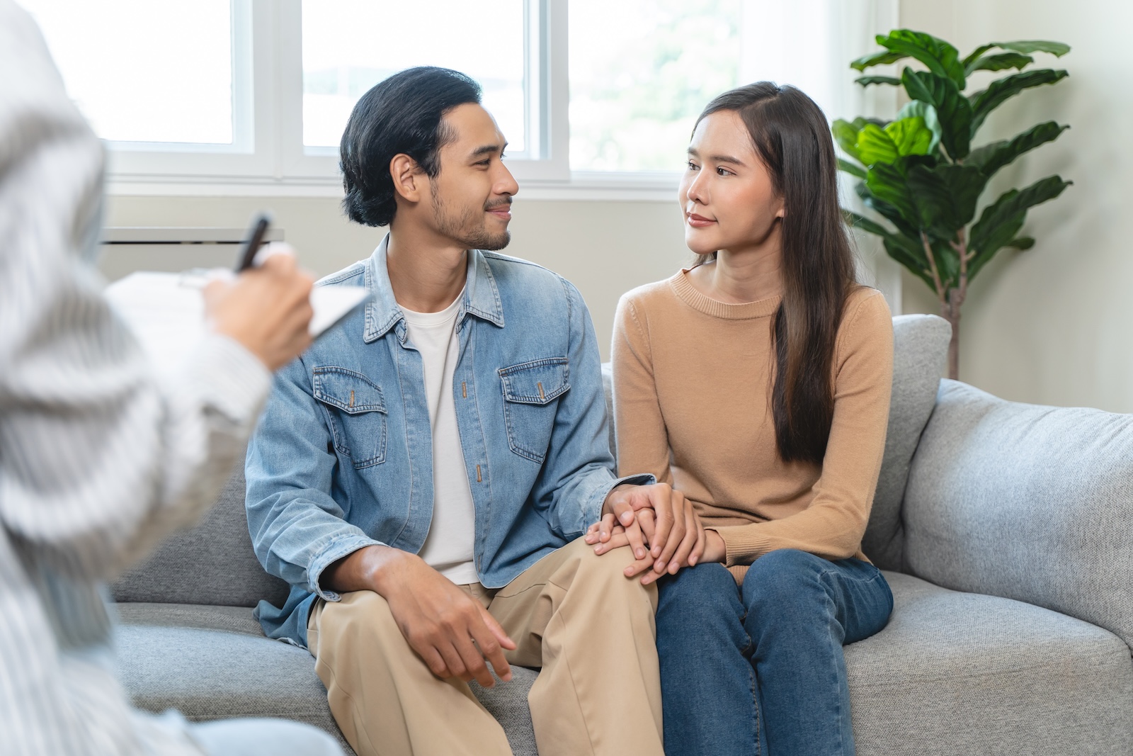Young couple sitting in a therapists office.