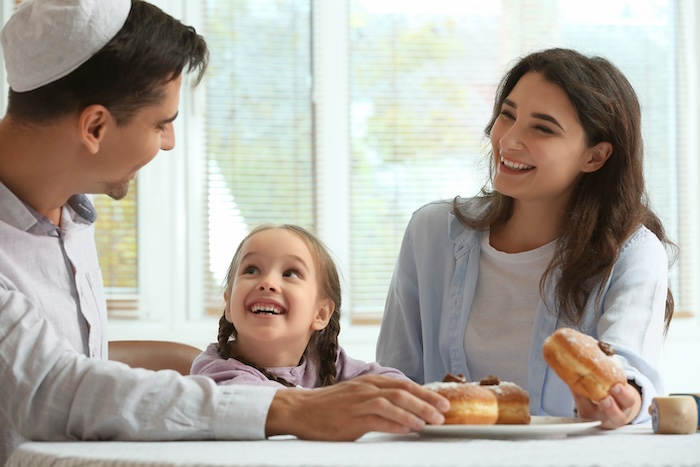 Happy family celebrating Hannukah at home
